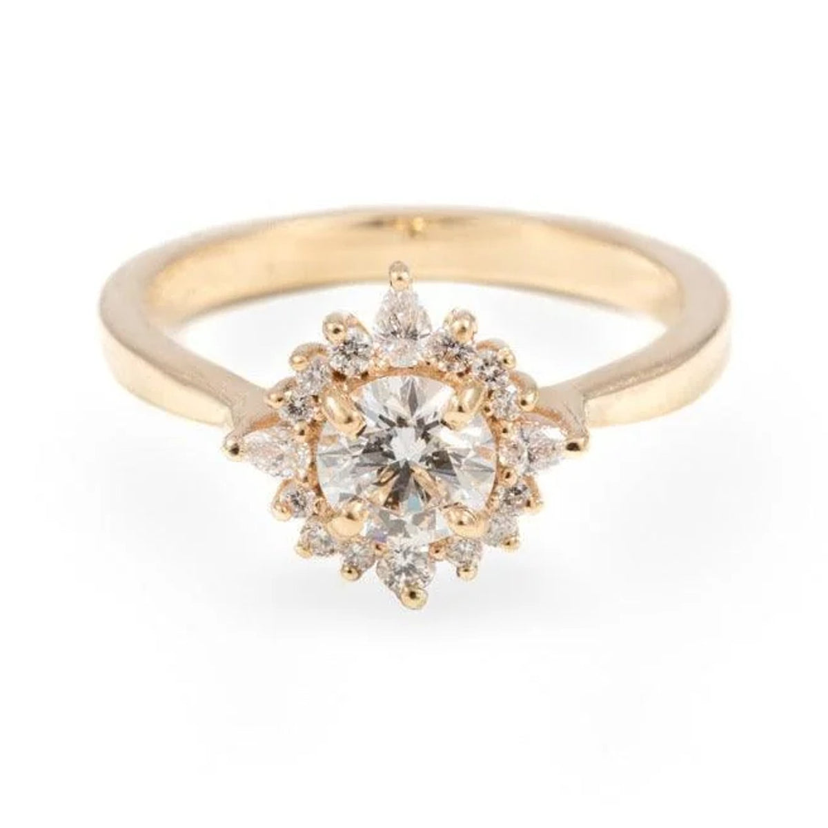 Fleur custom ring with a 0.5ct round diamond in a halo of smaller diamonds, yellow gold