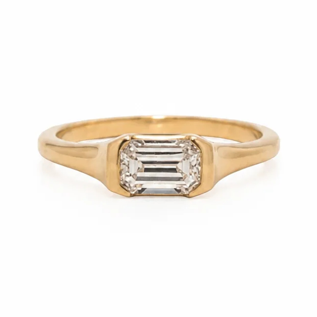 Emilia ring with an east-west emerald cut lab-grown diamond in a 14k gold partial bezel, front view
