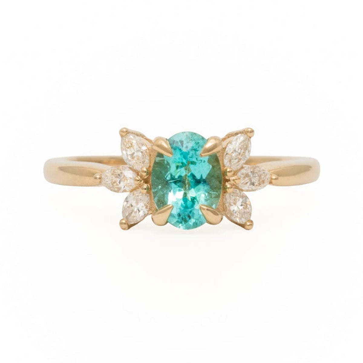 Annabella ring with a Paraiba tourmaline centre stone and diamond accents in 14k yellow gold, on a white background