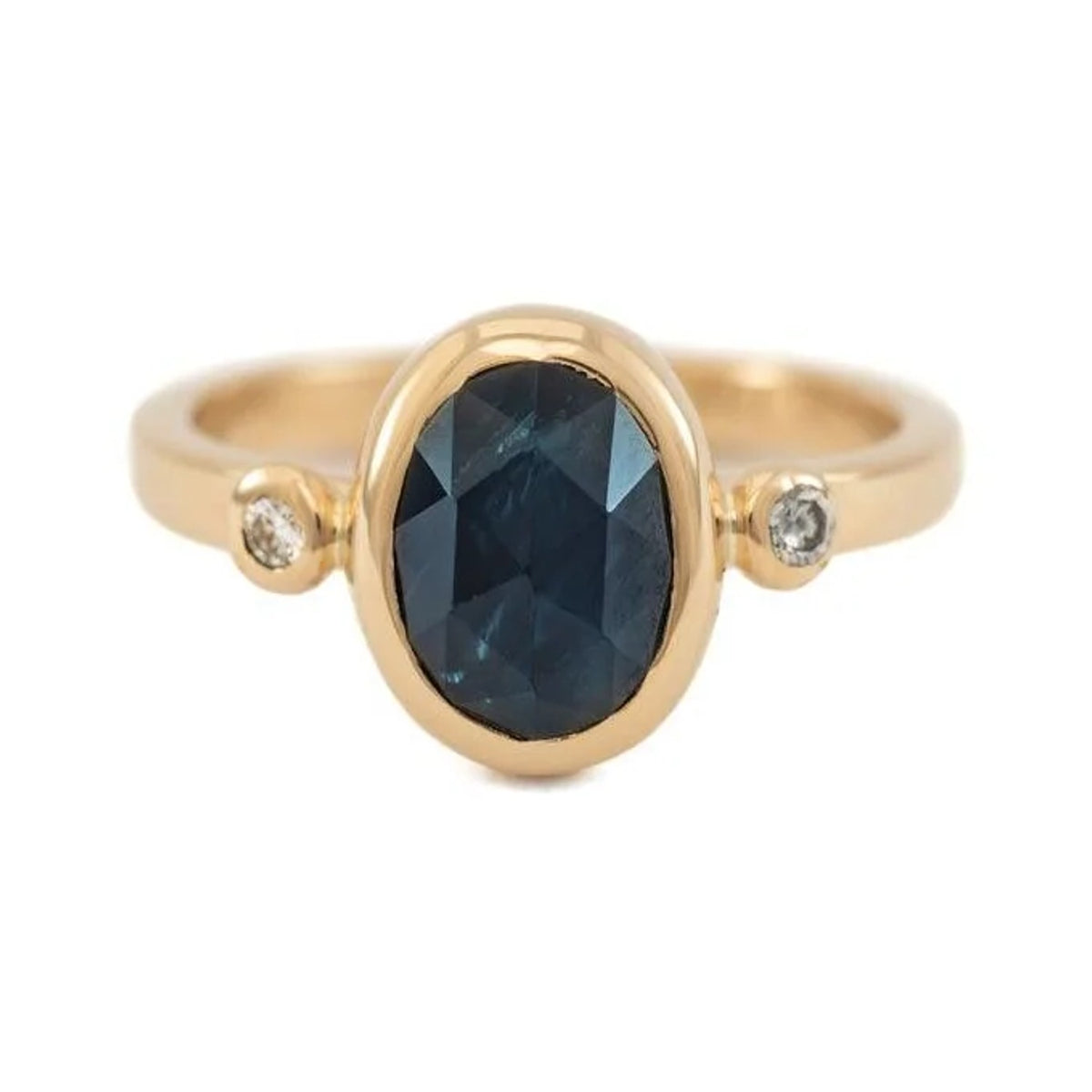 Eliza custom ring with an oval rose cut blue sapphire and two small side stones in gold