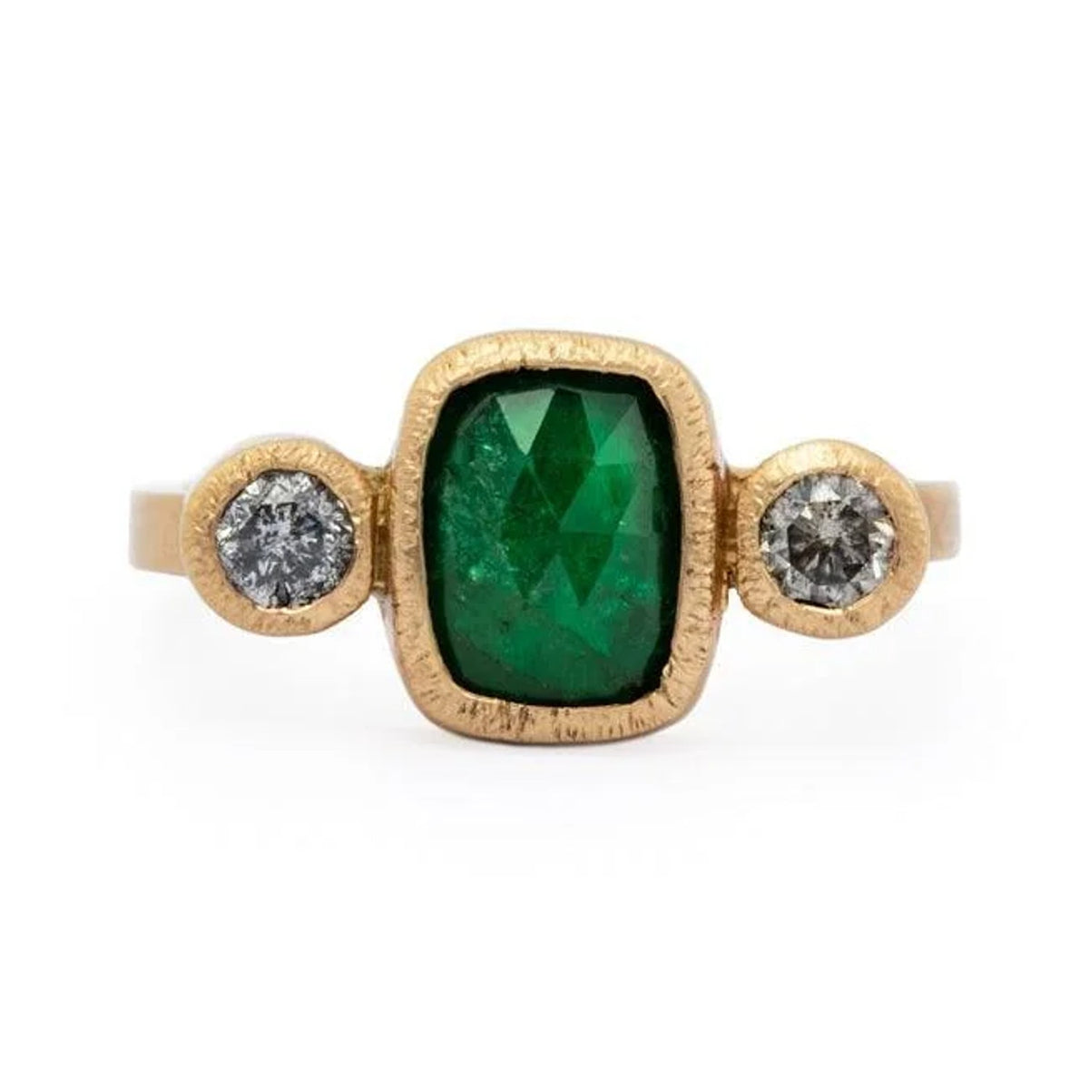 Emery custom ring with a cushion emerald and two diamonds in textured 14k gold, front view