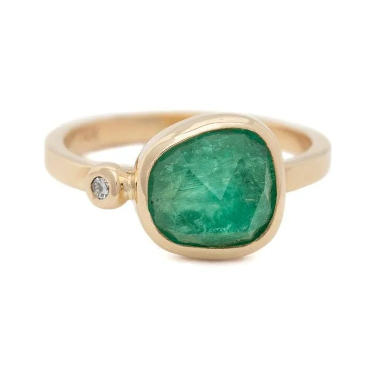Emersyn custom ring with a freeform emerald and a small diamond in a gold bezel