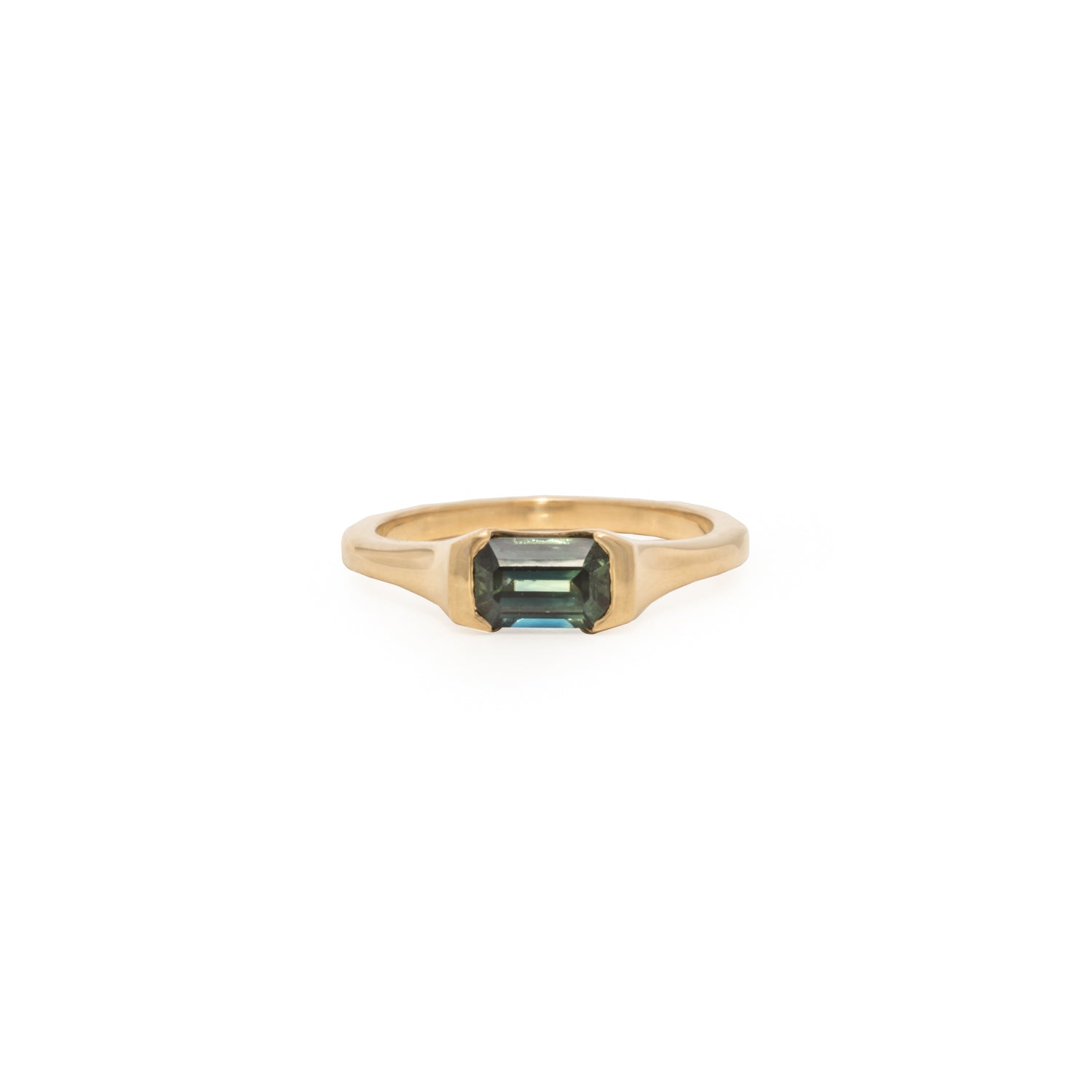 Gold ring with a sapphire gemstone on a white background