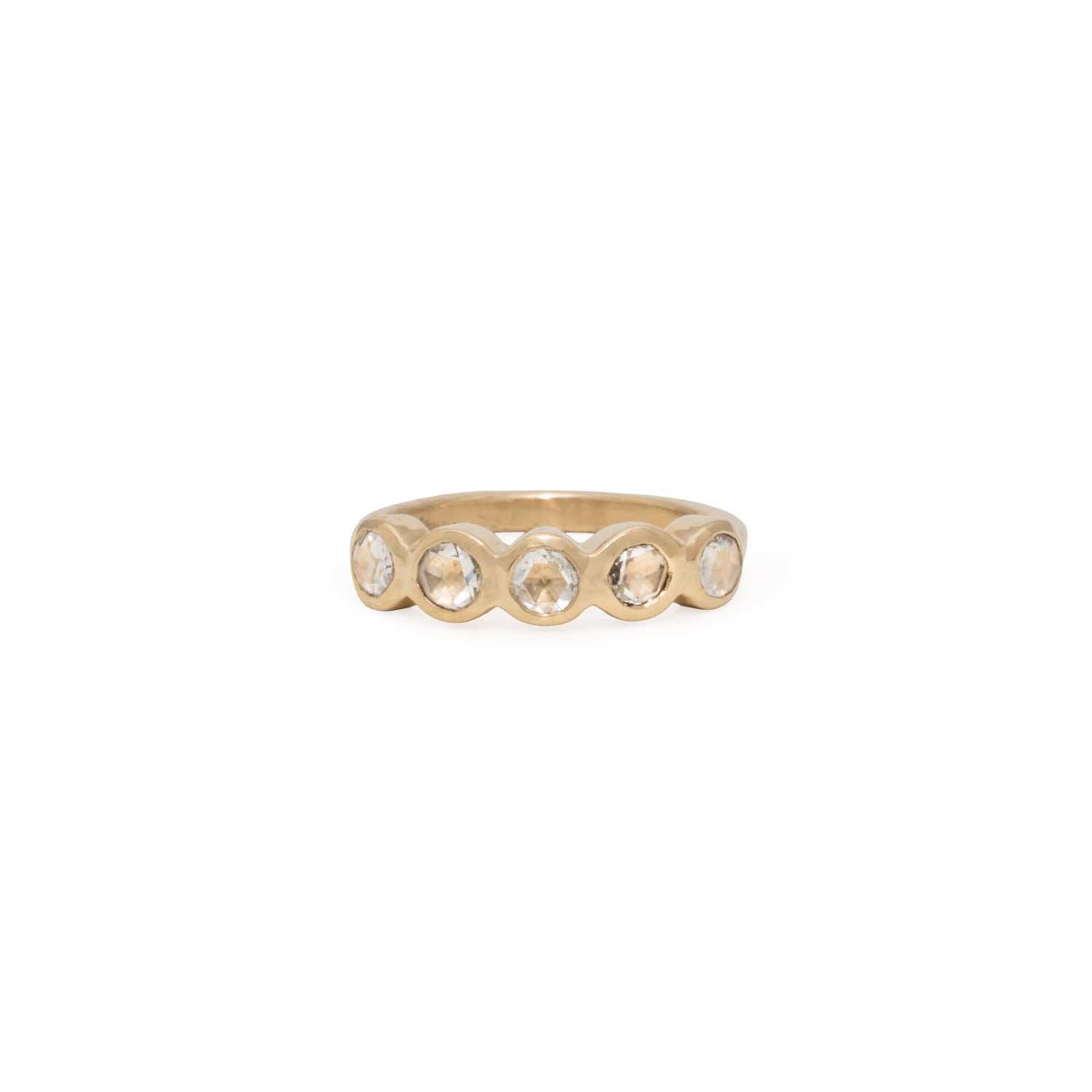 Gold ring with embedded stones on a white background