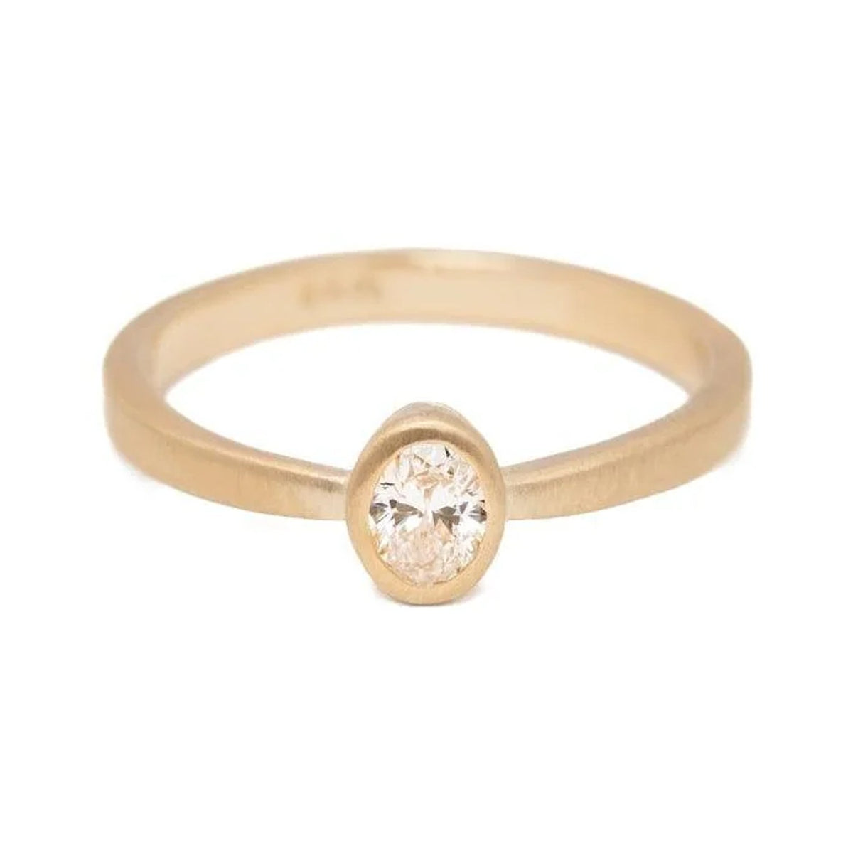 Laura oval diamond ring in matte 14k gold with a bezel setting, front view