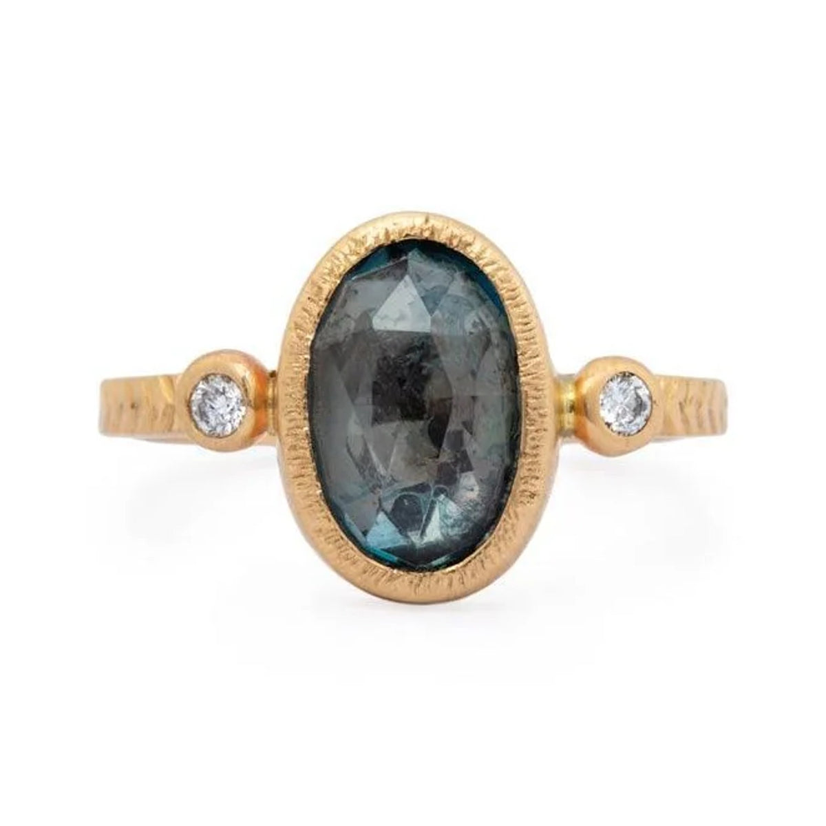 Lillian custom ring with an oval London blue topaz and two small side stones in textured 14k gold