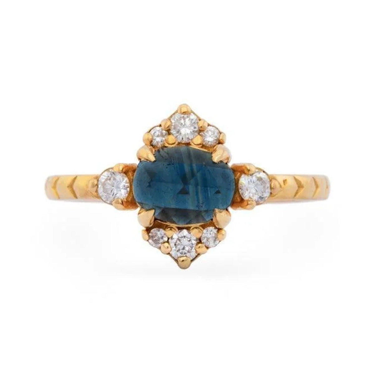 Olivia custom ring with an oval blue sapphire and diamond accents in 18k yellow gold