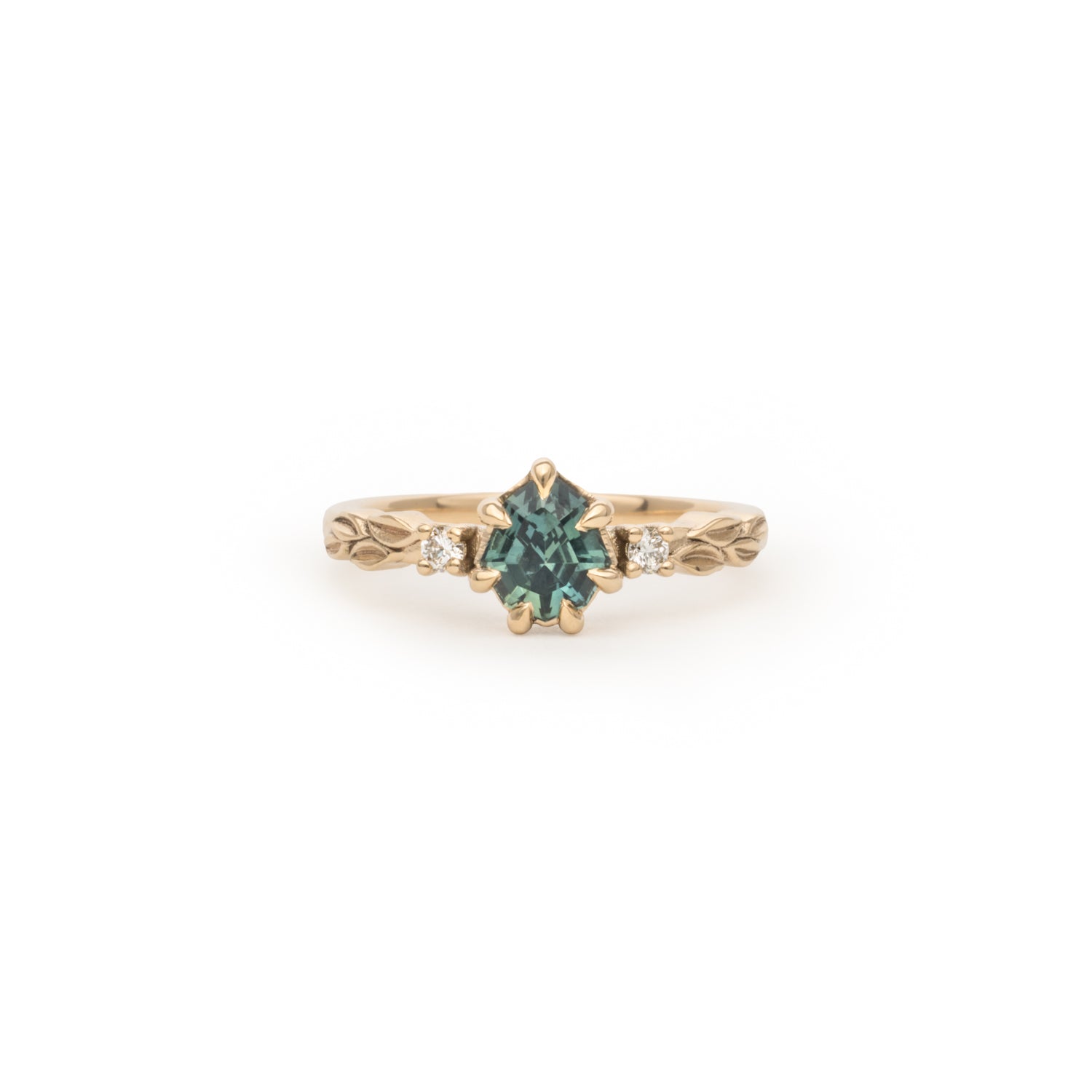 Rachel custom ring with a teal centre stone, two small white side stones and a leaf-engraved band, front view