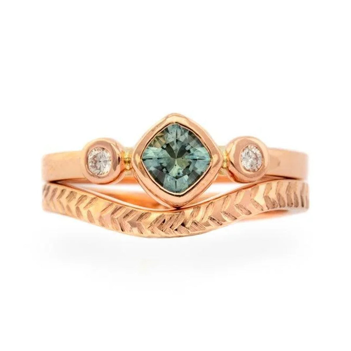 Dawn teal sapphire and diamond ring stacked with a curved chevron-engraved band, front view