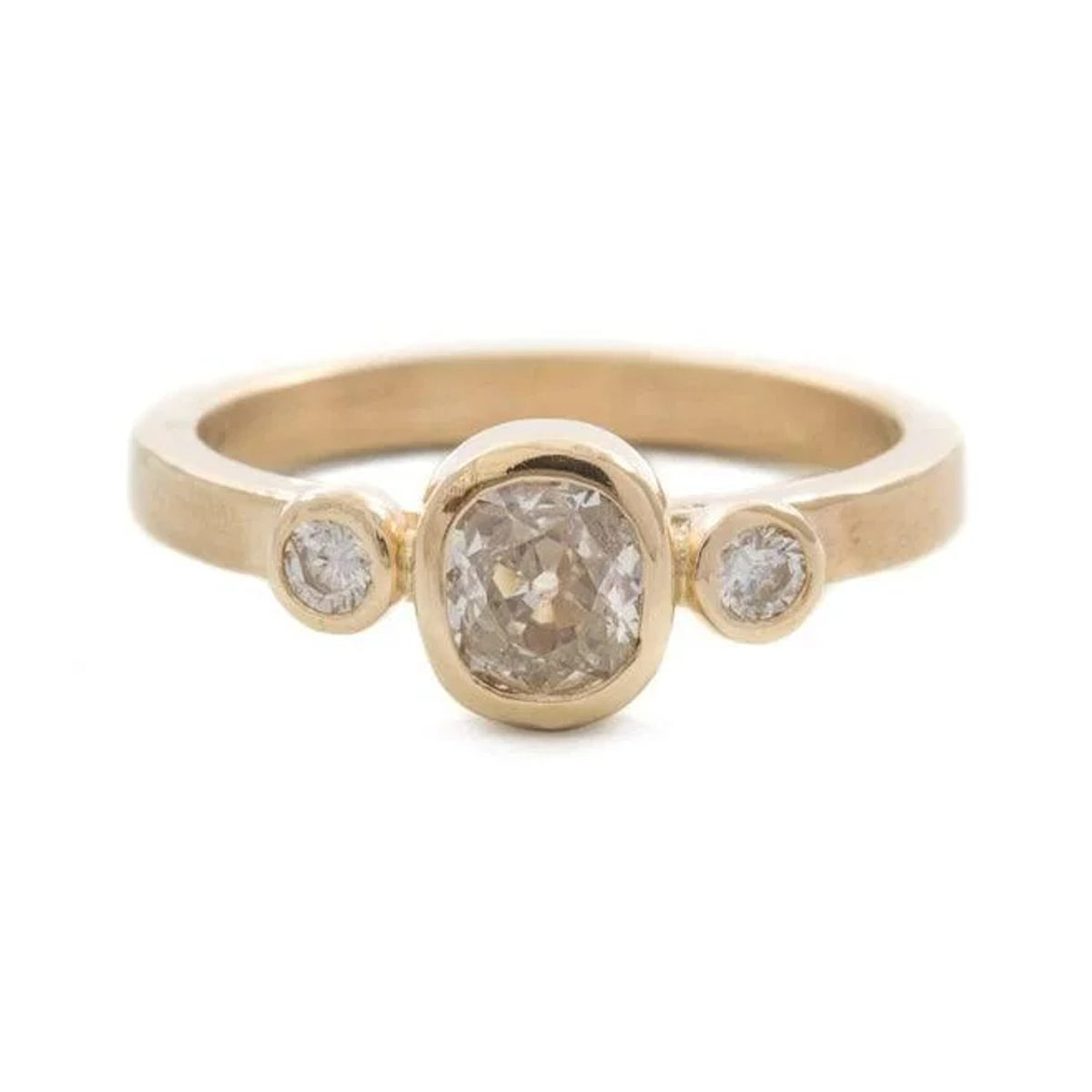 Valery engagement ring with an oval champagne-toned diamond and two round side stones in bezels, front view