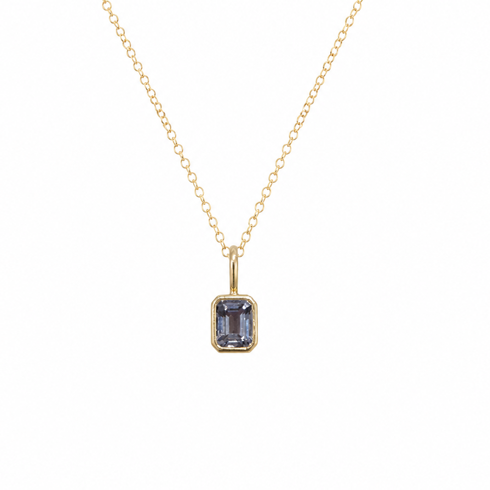 14 karat yellow gold pendant featuring a light purple spinel gemstone in a minimalist bezel setting on a fine gold chain. 