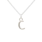 Silver necklace with a crescent moon pendant on a white background
