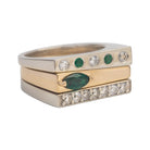 Stack of gold and white gold rings with green gemstones and diamonds. Custom ring.