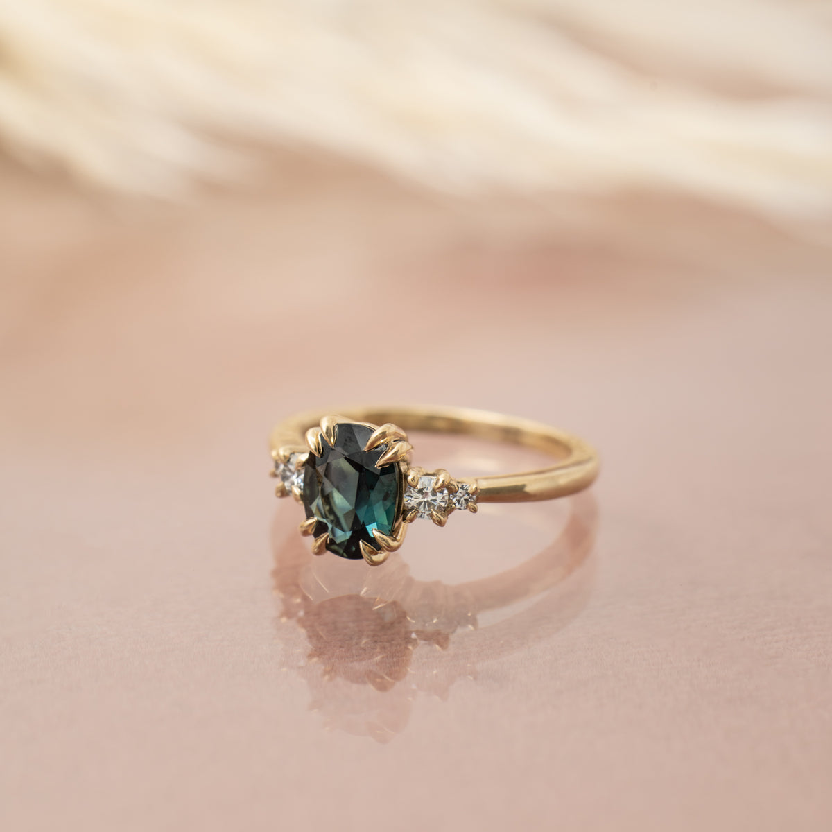 Kat Cadegan custom ring with sapphire and diamond and 14k golf. Prong setting.