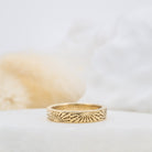 Soleil sunburst engraved gold wedding band, styled - Kat Cadegan